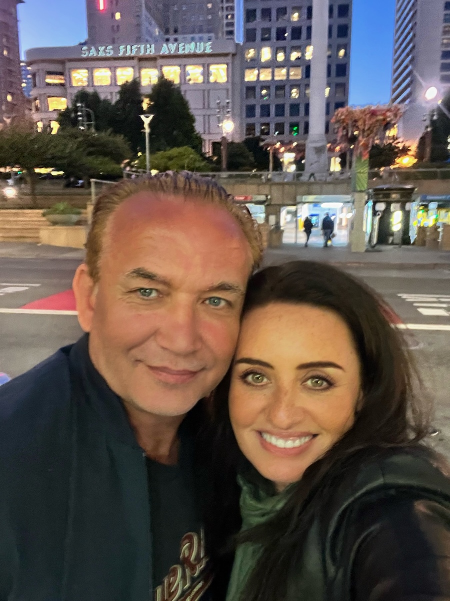 Tom and Tamara smiling together in the city
