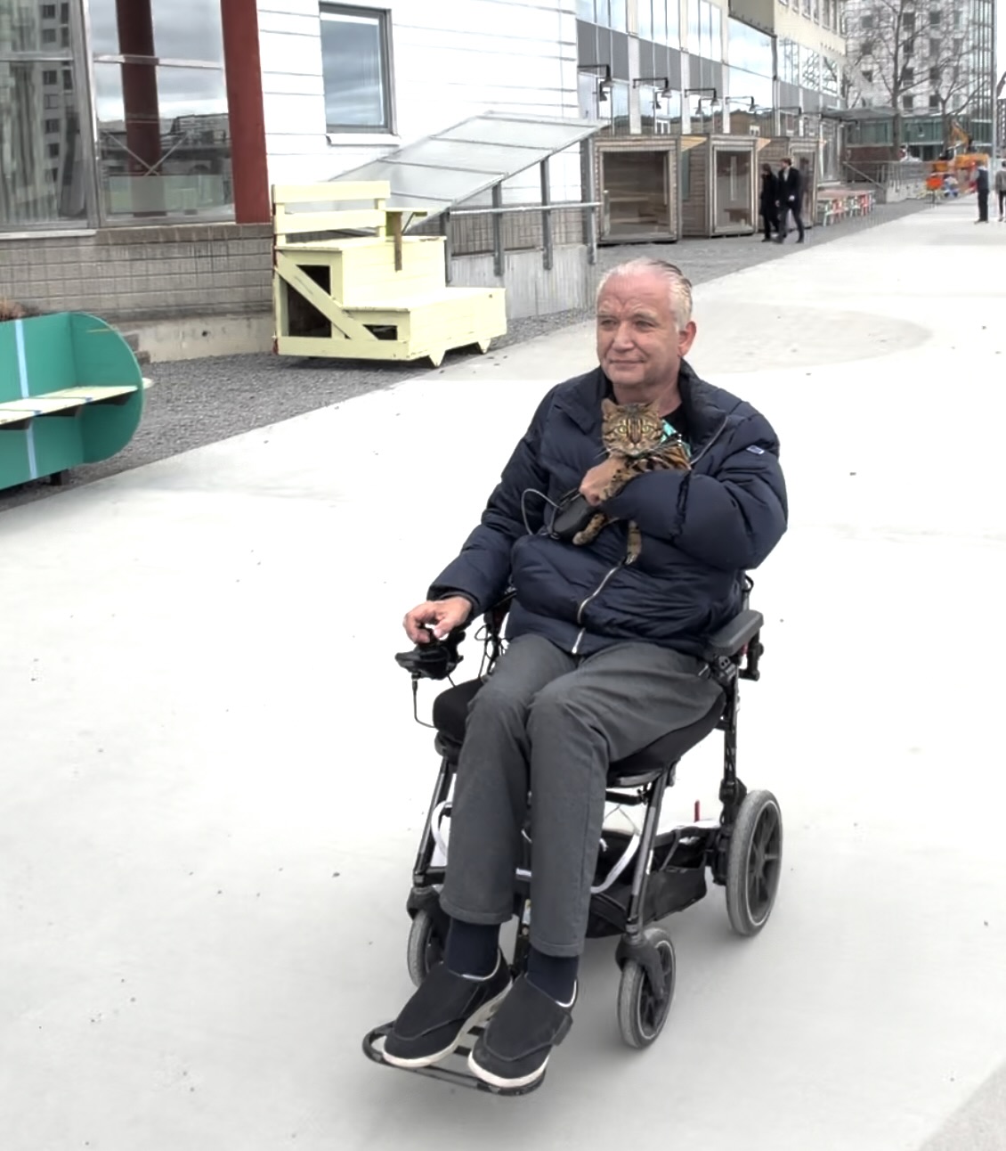 Tom outdoors in his wheelchair